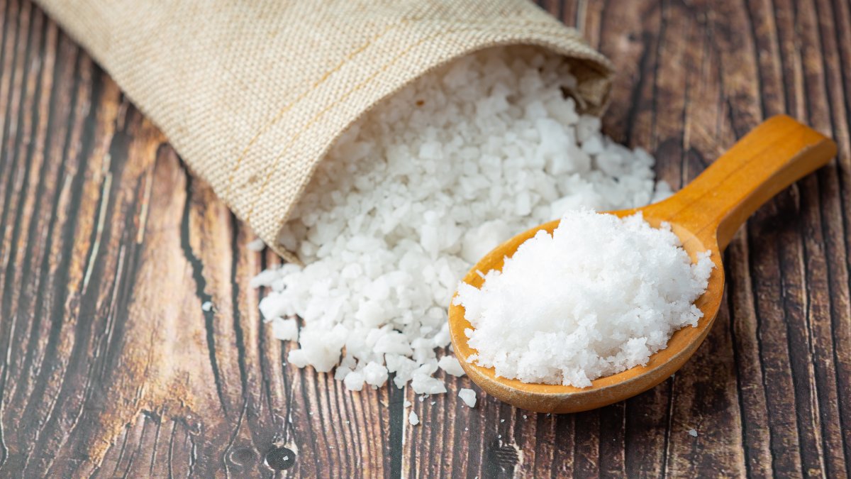 salt in wooden spoon place on floor