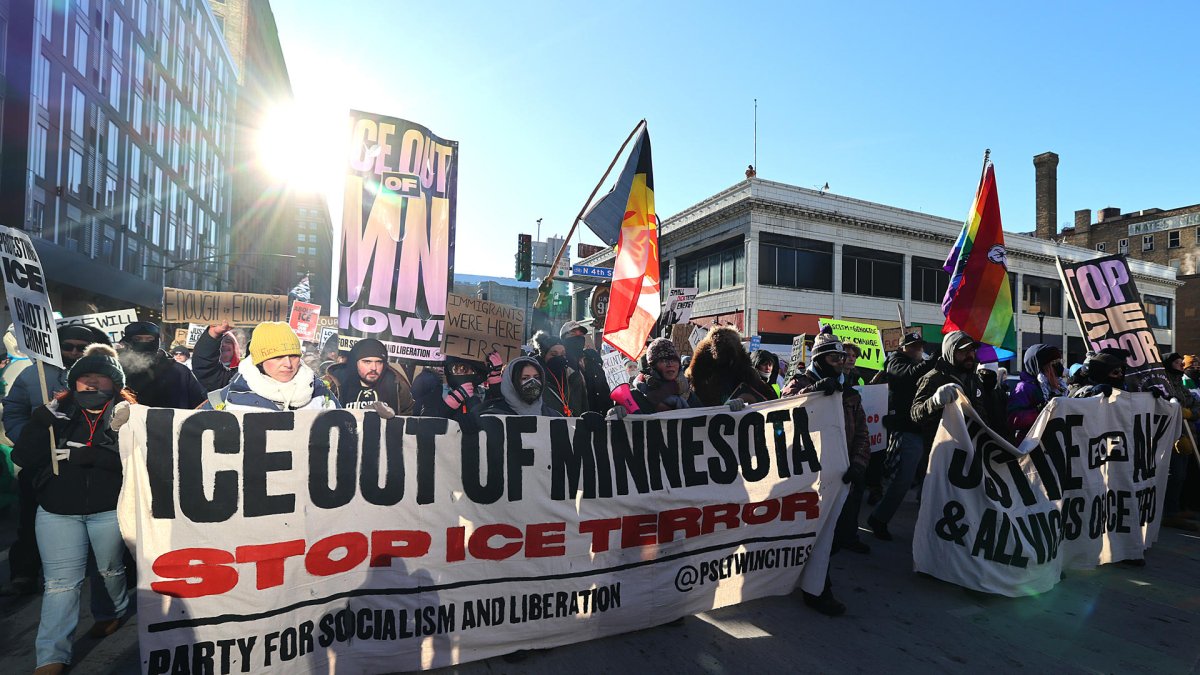 Personas sostienen carteles durante una marcha contra el Servicio de Inmigración y Control de Aduanas de Estados Unidos (ICE) en Mineápolis (EE.UU).