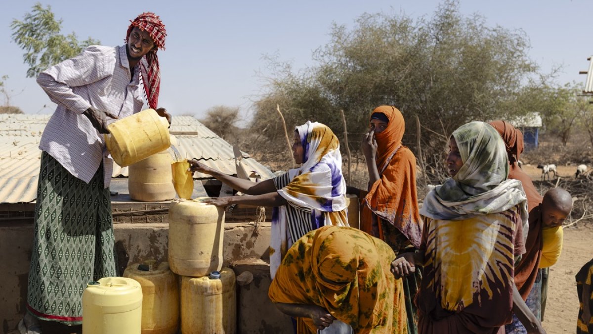 Los aldeanos recogen agua en bidones en un punto de la Cruz Roja de Kenia en la aldea de Hawara, cerca de la ciudad de Rhamu, el 21 de enero de 2026.
