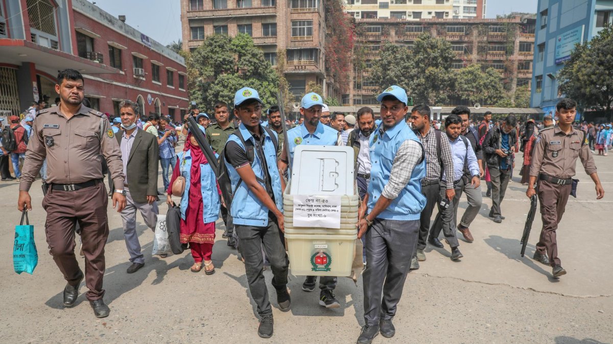 Personas trasladan el material para las elecciones en Daca, Bangladés.