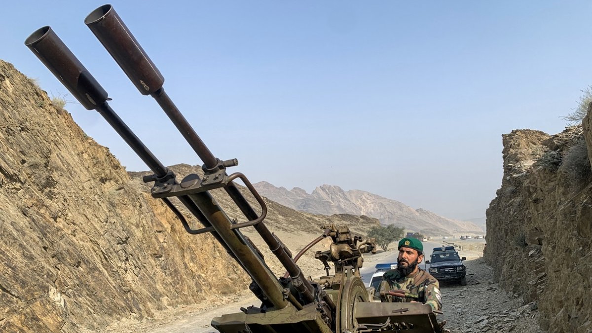 Un miembro de seguridad talibán que opera un cañón antiaéreo vigila los ataques aéreos paquistaníes cerca del cruce fronterizo de Torkham entre Afganistán y Pakistán.