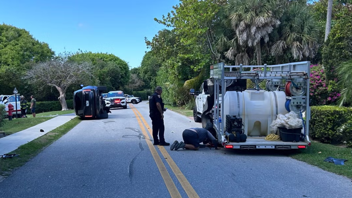Agentes de policía custodian el perímetro tras el choque de la camioneta negra perteneciente a Tiger Woods