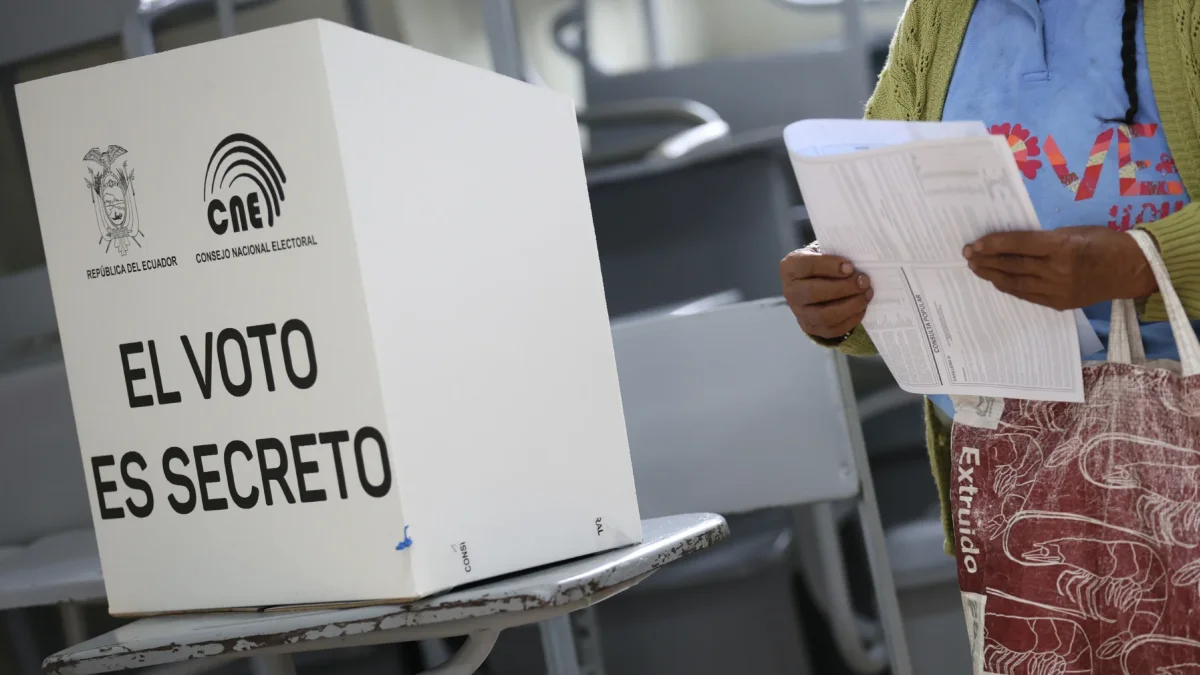 Ciudadana revisa su papeleta antes de ejercer el voto en un recinto electoral en Ecuador.