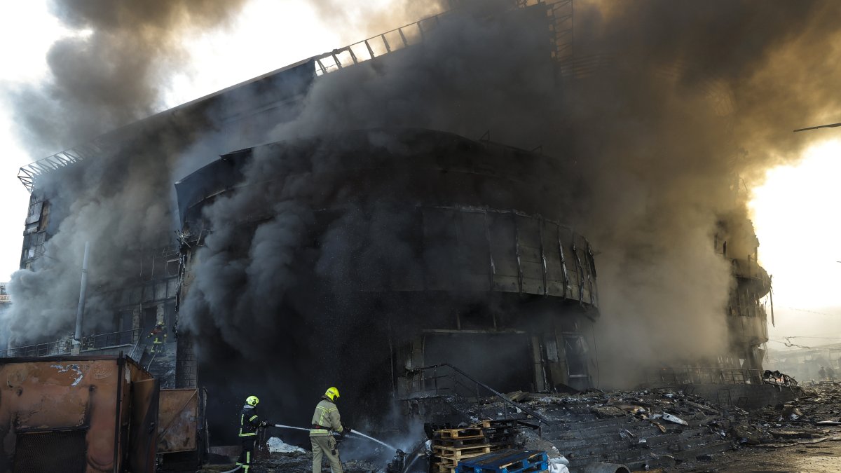 El humo se eleva mientras los rescatistas ucranianos trabajan en el lugar de un ataque ruso contra un centro comercial en Kiev, Ucrania.