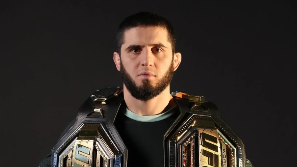 Islam Makhachev posa con los cinturones de campeón de Peso Ligero y Peso Welter de la UFC.