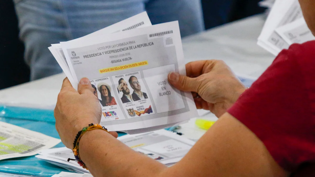 Ciudadano sostiene la papeleta de la segunda vuelta presidencial en Colombia, mientras el CNE reinicia el escrutinio sin definir aún al ganador.