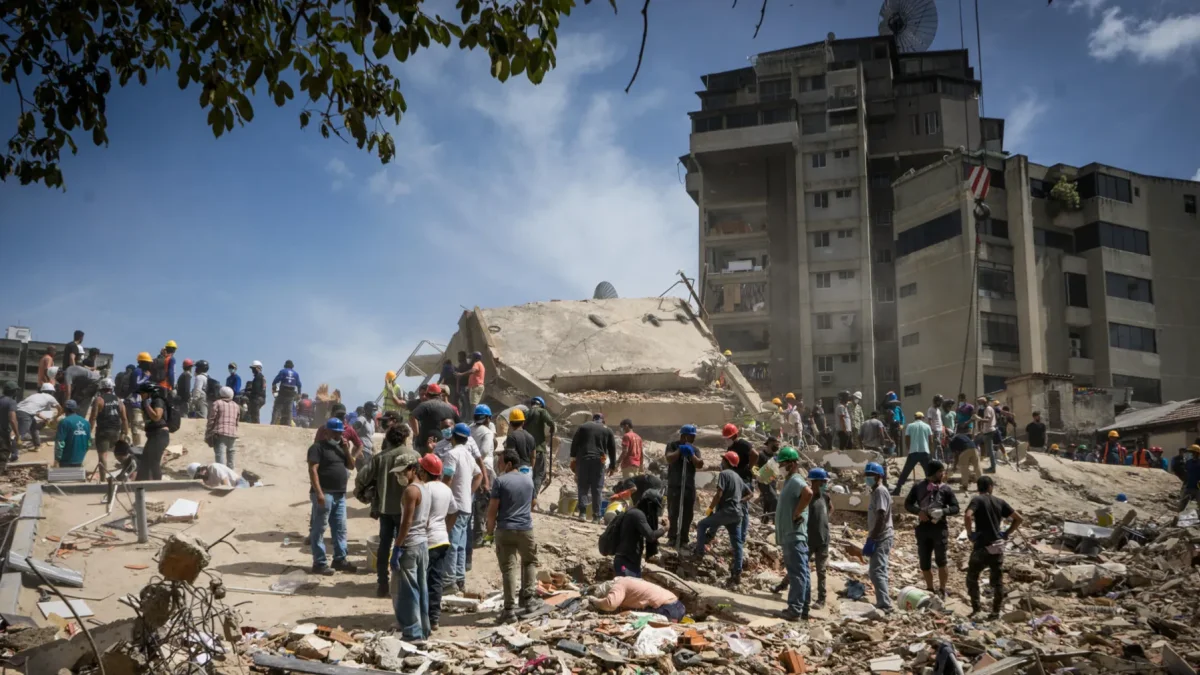 Rescatistas y voluntarios buscan víctimas en una vivienda afectada por los terremotos este jueves, en el municipio Libertador en el este de Caracas (Venezuela).
