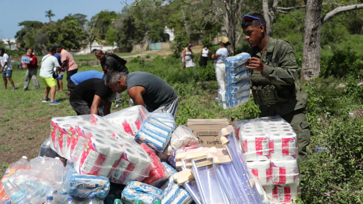 Personas descargan ayudas humanitarias este lunes en La Guaira, Venezuela, tras los sismos.