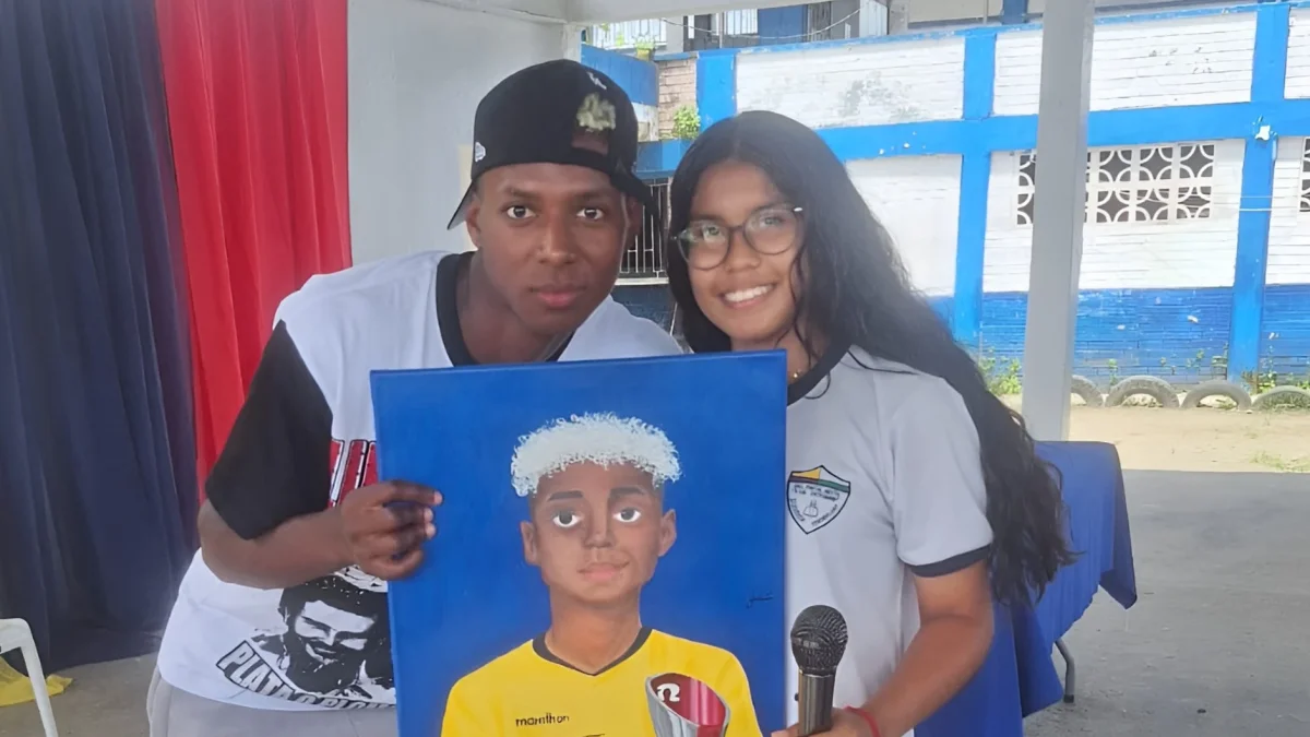 Camila Cotera entrega al mundialista ecuatoriano el retrato que pintó durante tres días.