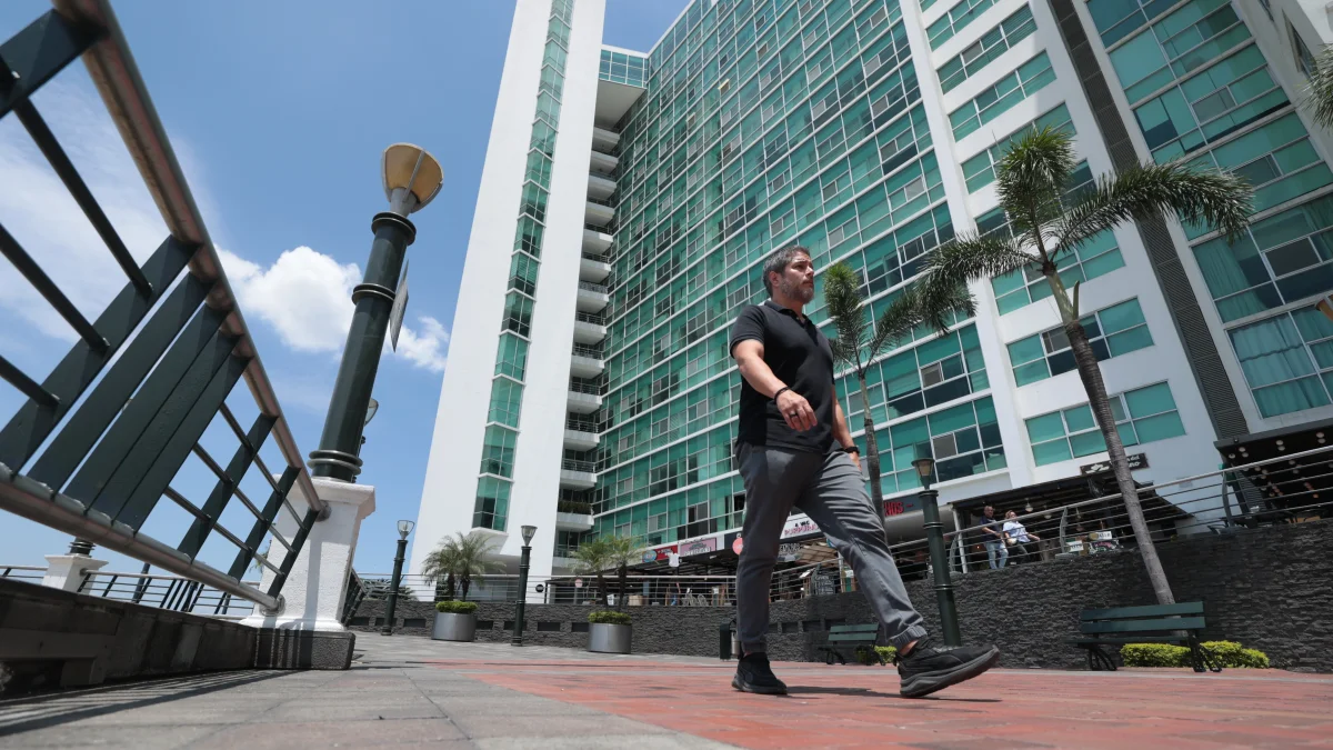 Una persoma camina al pie de los condominios que quedan en Puerto Santa Ana, en Guayaquil.