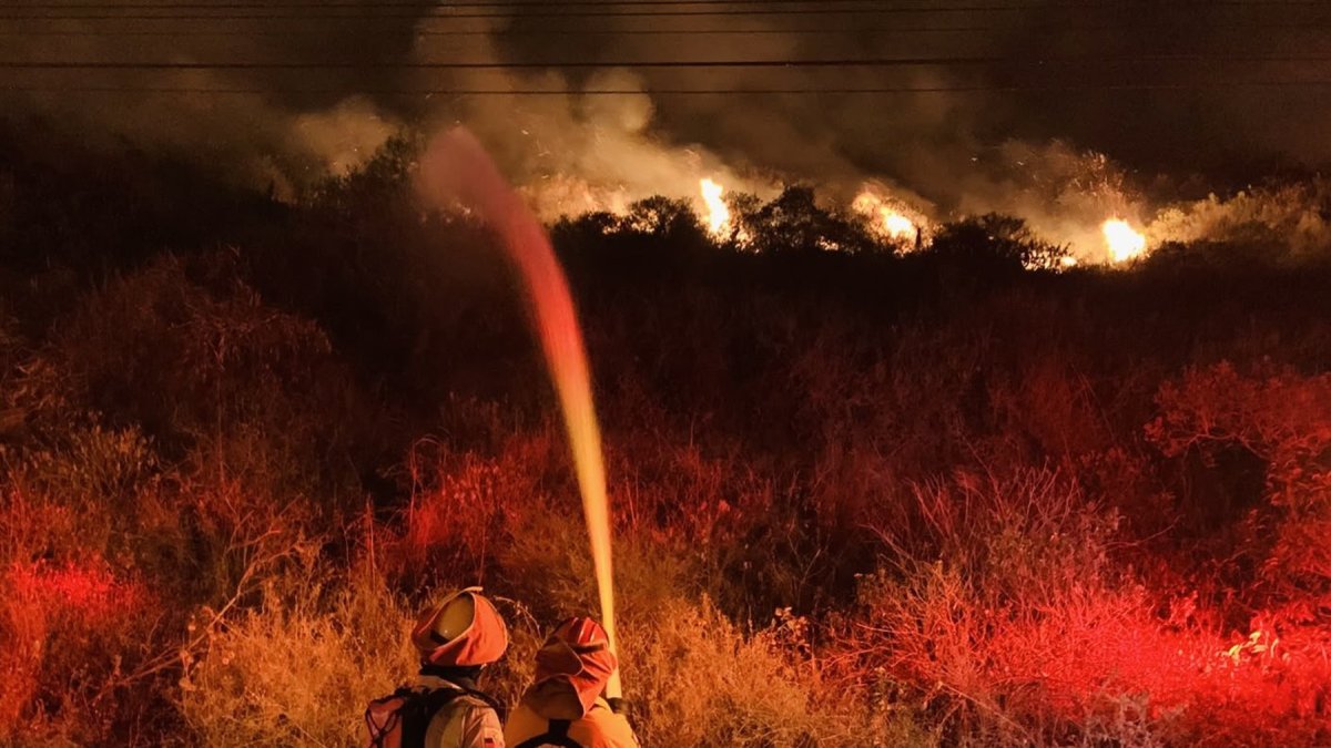 Bomberos de Quito intentan sofocar las llamas en el cerro Casitagua.