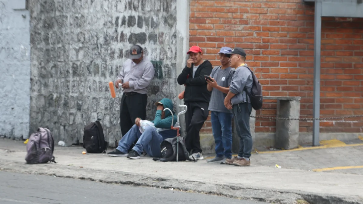 Un grupo de trabajadores con herramientas espera en una vereda. El INEC no publica cifras oficiales de empleo desde mayo y aplazó los datos de junio a octubre hasta el 22 de diciembre.