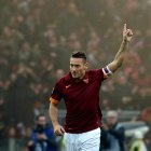Roma"s forward Francesco Totti celebrates after scoring during the Italian Serie A football match AS Roma vs Lazio on January 11, 2015 at the Olympic Stadium in Rome. AFP PHOTO / TIZIANA FABI (Photo credit should read TIZIANA FABI/AFP/Getty Images)