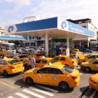 Un grupo de taxis hacen fila para poner combustible en una gasolinera en Guayaquil.