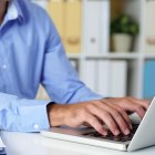 Cropped image of businessman working on laptop