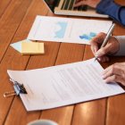 Close-up image of entrepreneur checking document before signing