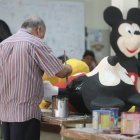 Usuarios del Instituto de Neurociencias, de la Junta de Beneficencia,construyen monigotes para la venta.