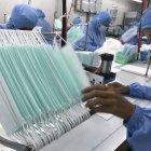 Workers produce masks at the Thai Hospital Product Company Ltd. factory in Bangkok on January 30, 2020. - A Thai surgical mask factory, producing 10 million masks a month, increased working hours to cope with the rising demand following an outbreak of SARS-like virus in China, with their product exported mostly to US and Europe the rest sold on the domestic market. (Photo by Jonathan KLEIN / AFP)