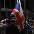 Staff members take down the United Kingdom"s flag from the European Parliament building in Brussels on Brexit Day, January 31, 2020. - Britain leaves the European Union at 2300 GMT on January 31, 2020, 43 months after the country voted in a June 2016 referendum to leave the block. The withdrawal from the union ends more than four decades of economic, political and legal integration with its closest neighbours. (Photo by JOHN THYS / AFP)