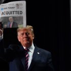 US President Donald Trump holds up a newspaper that displays a headline "Aquitted"  as he arrives to speak at the 68th annual National Prayer Breakfast on February 6, 2020 in Washington,DC. President Donald Trump said Thursday that he suffered a "terrible ordeal" during his impeachment. In his first public comments since being acquitted by the Senate of abuse of office, he said he had been "put through a terrible ordeal by some very dishonest and corrupt people." "They have done everything possible to destroy us and by so doing very badly hurt our nation," he said at a televised prayer breakfast with a Who"s Who of Washington power brokers.
 / AFP / Nicholas Kamm

 US-POLITICS-PRAYER-TRUMP