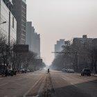 PEKÍN. Una persona transita por una avenida totalmente desolada. El temor y las restricciones aumentan en China, a causa del coronavirus.