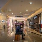 PEKÍN. Un hombre descansa en medio de un pasillo de uno de los centros comerciales más concurridos en esta capital, donde sus habitantes siguen en sus casas por temor al contagio de coronavirus.