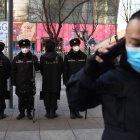 Security guards wearing protective face masks, amid concerns of the COVID-19 coronavirus outbreak, patrol in a shopping area in Beijing on February 17, 2020.   The death toll from China"s COVID-19 coronavirus epidemic jumped to 1,770 after 105 more people died, the National Health Commission said on February 17. More than 70,500 have now been infected nationwide by the virus, which first emerged in December in central Hubei province before spreading across the country. / AFP / GREG BAKER

 CHINA-HEALTH-VIRUS