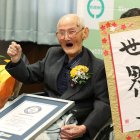 (FILES) In this Japan Pool picture received via Jiji Press on February 12, 2020, 112-year-old Japanese man Chitetsu Watanabe poses next to calligraphy reading in Japanese "World Number One" after he was awarded as the world"s oldest living male in Joetsu, Niigata prefecture. - A Japanese man recently named the world"s oldest living male has died aged 112, a local official said on February 25, 2020. (Photo by JAPAN POOL / JIJI PRESS / AFP) / Japan OUT
