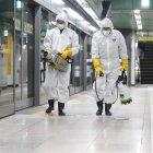 Workers wearing protective gear spray disinfectant as part of preventive measures against the spread of the COVID-19 coronavirus, at a subway station in Seoul on February 28, 2020. - K-pop megastars BTS on February 28 cancelled four concerts they were due to hold in Seoul in April, their agency said, as the coronavirus outbreak spreads in South Korea. The country has so far confirmed more than 2,000 cases of the novel coronavirus, by far the largest national total outside China, the origin of the disease. (Photo by - / YONHAP / AFP) / - South Korea OUT / REPUBLIC OF KOREA OUT  NO ARCHIVES  RESTRICTED TO SUBSCRIPTION USE