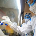 This photo taken on February 19, 2020 shows laboratory technicians testing samples of virus at a laboratory in Hengyang in China"s central Henan province. - The death toll from the COVID-19 coronavirus epidemic jumped to 2,112 in China on February 20 after 108 more people died in Hubei province, the hard-hit epicentre of the outbreak. (Photo by STR / AFP) / China OUT