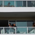 A family clean their balcony in Santiago, Chile, march 28, 2020.  More than 1.3 million people of seven of the main communes of Santiago were placed into total quarantine aiming to curb the spread of the novel coronavirus, COVID-19. / AFP / MARTIN BERNETTI

 CHILE-HEALTH-VIRUS