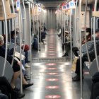 MILÁN. (Italy), 27/04/2020.- People wearing face masks respect social distancing measures while seated inside a subway carriage in Milan, northern Italy, 27 April 2020, during the coronavirus disease (COVID-19) pandemic. (Italia) EFE/EPA/