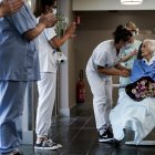 Medical workers clap as Belgian 100 year-old patient Julia Dewilde leaves the Bois de l"Abbaye hospital (CHBA) in Seraing, after being succesfully treated for COVID-19, the disease caused by the novel coronavirus, on April 29, 2020. (Photo by Kenzo TRIBOUILLARD / AFP)