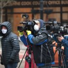 CHICAGO, ILLINOIS - APRIL 30: Journalist wearing masks document a protest where demonstrators were calling on the governor to suspend rent and mortgage payments to help those who have lost their income due to the coronavirus on April 30, 2020 in Chicago, Illinois. On May 1, the state of Illinois will begin requiring everyone to wear a face mask in public when social distancing is not possible to prevent the spread of the coronavirus COVID-19. The state is currently on a "stay at home" mandated by the governor until May 30.   Scott Olson/Getty Images/AFP