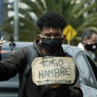 Un hombre vende dulces y pide ayuda en un semáforo en Bogotá (Colombia). EFE/Mauricio Duenas Castañeda