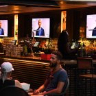 Former US President Barack Obama is seen on television screens as he speaks during the third day of the Democratic National Convention, being held virtually amid the novel coronavirus pandemic, at The Abbey bar and restaurant in West Hollywood, California, August 19, 2020. (Photo by Robyn Beck / AFP)