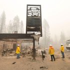 Shaver Lake. Bomberos recorren el lugar donde hasta inicios de semana estaba una tienda. Solo queda el letrero en pie, tras el paso del incendio.