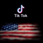 (FILES) In this file photo illustration taken on September 14, 2020, shows the logo of the social network application TikTok and a US flag on the screens of two laptops in Beijing. - US officials on September 18, 2020, ordered a ban on downloads of the popular Chinese-owned mobile applications WeChat and TikTok from September 20, saying they threaten national security. The move comes amid rising US-China tensions over technology and a Trump administration effort to engineer a sale of the video app TikTok to American investors. (Photo by NICOLAS ASFOURI / AFP)