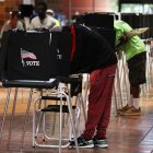 MIAMI, FLORIDA - OCTOBER 21: Voters fill out their ballots as they vote at the Stephen P. Clark Government Center polling station on October 21, 2020 in Miami, Florida. The state of Florida saw a record-breaking first day of early voting with over 3.1 million votes cast. The early voting ends on Nov. 1. Voters are casting their ballots for presidential candidates President Donald Trump and Democratic presidential nominee Joe Biden.   Joe Raedle/Getty Images/AFP