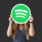 Cheerful woman holding emoticon icon