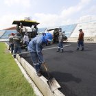 Una cuadrilla colocó la primera capa asfáltica donde irá el material sintético.