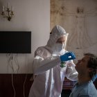 A healthcare worker wearing personal protective equipment (PPE) takes a swab sample from a homeless man in a hotel in Prague, Czech Republic, 01 March 2021 (issued 02 March 2021). Lockdown and measures against COVID-19 disease caused by the SARS-CoV-2 coronavirus led to the temporary closure of hotels in the Czech Republic. Councilors in Prague, the capital of the country with one of the largest infection rates in the EU, took the opportunity to rent these tourist place and accommodate homeless people who tested positive for coronavirus. The City of Prague in cooperation with the Center of Social Services of Prague, opened the first "Covid house" in a 4-star hotel in November 2020. Currently there are three facilities in Prague with a capacity for 181 people. According to the Czech Ministry of Labour and Social Affairs, it is estimated that there are about 3,250 homeless people in Prague, and the incidence of COVID-19 disease among them is increasi