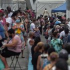 Grupos de personas hacen fila para recibir la vacuna contra la Covid-19 hoy, en la ciudad de Duque de Caxias (Brasil).