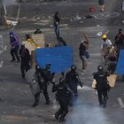 Manifestantes se enfrentan con miembros del Escuadrón Móvil Antidisturbios (ESMAD) durante las protestas hoy en Cali (Colombia).