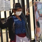 Pilar Reyes, una humilde mujer quechua, protesta atando sus manos con cinta adhesiva a la reja del Tribunal Departamental de Justicia de Cochabamba (Bolivia). EFE/Jorge Abrego