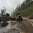 Maquinaria pesada realiza la limpieza de una vía afectada por deslaves.