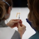 Dos enfermeras observan una dosis de vacuna contra la covid-19, en foto de archivo.