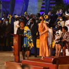 En el acto, Rihanna lució un vestido de seda naranja largo, combinado con unas sandalias negras y unas trenzas en el pelo.