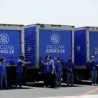 Vista de trabajadores de la salud junto a camiones refrigerantes que transportarán un lote de vacunas, en una fotografía de archivo.