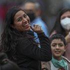 Grupos de personas con y sin mascarillas caminan hoy, por las calles de Quito.